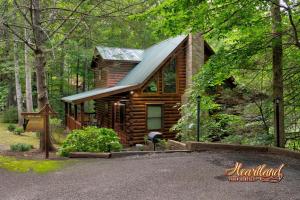 a log cabin in the woods with a porch at Southern Comfort in Sevierville