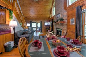 a dining room with a table and a fireplace at Southern Comfort in Sevierville