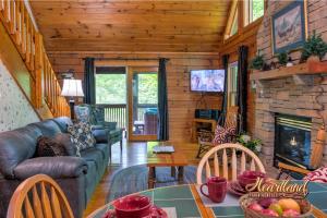 a living room with a couch and a fireplace at Southern Comfort in Sevierville