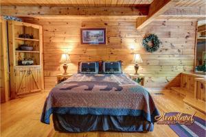 a bedroom with a bed in a log cabin at Southern Comfort in Sevierville