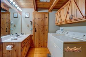a bathroom with a sink and a washing machine at Southern Comfort in Sevierville +24 photos