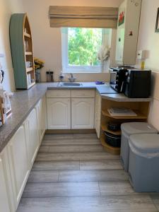 a kitchen with a sink and a window at Town Centre Apartment in Mold