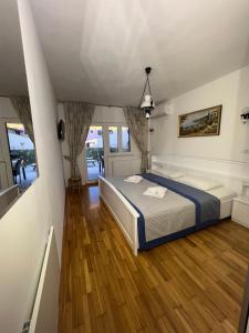 a bedroom with a bed and wooden floors at Viola Istra Guest House in Štinjan
