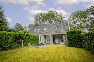 a house with a yard with a fence at Superb 90m2 Apartment with Garden in Eindhoven