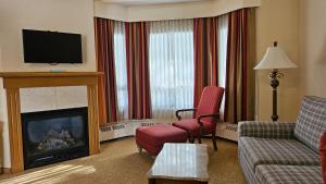 a living room with a couch and a fire place at Lake Louise Inn in Lake Louise