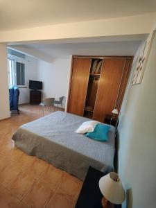 a bedroom with a bed with a wooden headboard at PORTO SANTO MyLove in Porto Santo