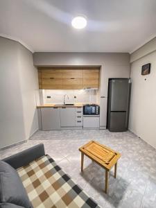 a kitchen with a couch and a table in a room at Olive Garden by Golden Host in Nea Moudania +5 photos