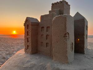 a sand castle on the beach at sunset at Strandschönheit in Wangerooge