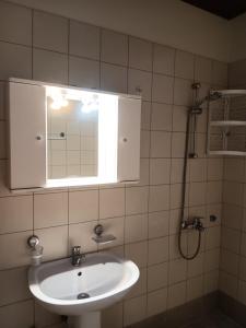 a bathroom with a sink and a mirror and a shower at Apartments Kidonis in Limenaria +69 photos