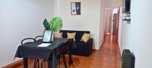a living room with a table and a couch at Departamentos La Perón in Villa Mercedes
