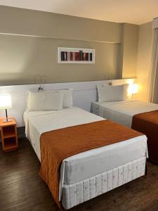Cama ou camas em um quarto em Intercity BH Expo