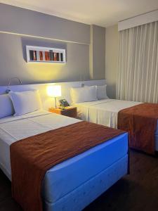 Cama ou camas em um quarto em Intercity BH Expo
