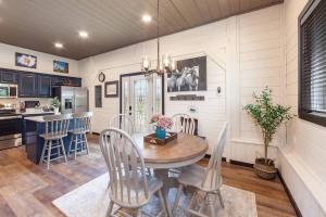 a kitchen and dining room with a table and chairs at Smoky Mtn Retreat Pets Pickleball HotTub Creekside in Sevierville