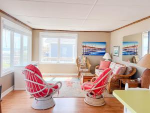a living room with red chairs and a couch at Lungomare in Surf City