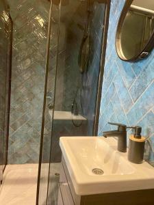 a bathroom with a sink and a shower at City apartment in Pärnu +9 photos