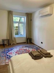 a bedroom with a bed and a window and a rug at City apartment in Pärnu