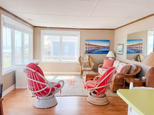 a living room with two red chairs and a couch at Lungomare in Surf City