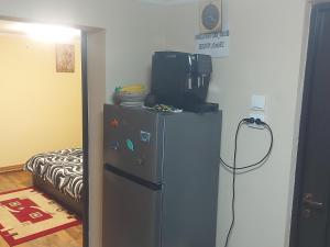 a small refrigerator with a television on top of it at Casa de vacanta in Tara Fagarasului in Beclean