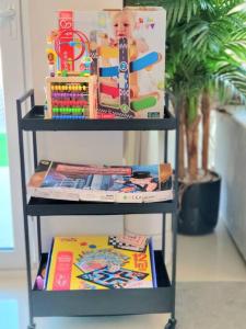 a toy shelf with a baby picture and a box at Damac Hills 2 Retreat- Tranquil Luxe, Beyond City with waterpark in Dubai