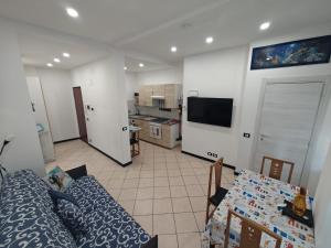 a living room with a couch and a kitchen at Ca' Barabino in Genoa