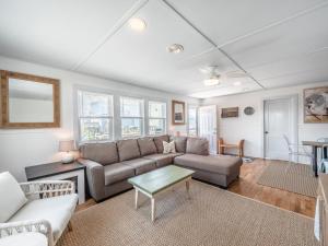 a living room with a couch and a table at Mountains to Sea in Topsail Beach