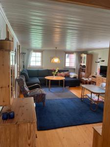 a living room with a couch and a table at Yngsjö, Aspvägen in Yngsjö