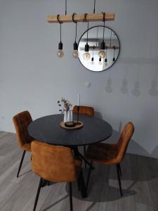 a dining room table with chairs and a chandelier at Apartment Paola - Šibenik in Šibenik