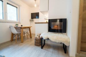 un soggiorno con camino e tavolo di Apartment Loyd, Kranjska Gora - studio a Kranjska Gora
