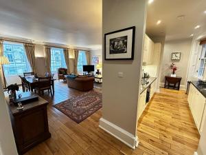 a living room with a kitchen and a dining room at Parliament Sq (apt 10 ) Royal Mile in Edinburgh