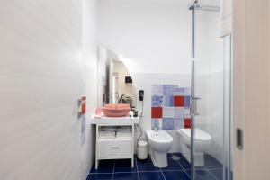 a bathroom with a sink and a toilet at VENART by AnrealeRooms in Paestum +19 photos