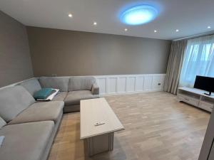 a living room with a couch and a table at 2 Bedroom flat for rent in Daugavpils