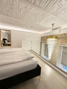 a bedroom with a bed and a brick wall at Budapest Central Opera with Gym & Spa in Budapest