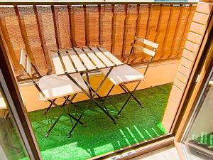 a table and chairs sitting on a balcony at Carlys House - Calzada de Ponga 5 in Cangas de Onís
