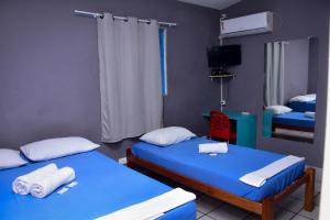 a room with two beds and a tv in it at STAY POUSADA in Recife
