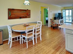 a kitchen and dining room with a table and chairs at On Island Time in Topsail Beach