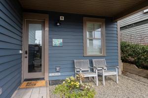 two chairs sitting outside of a blue house at Sea Esta by Seabrook Hospitality in Pacific Beach +37 photos