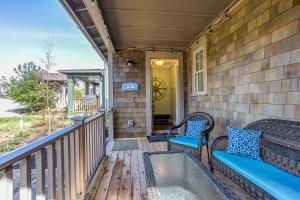 a porch with two chairs and a hot tub at Sea Esta by Seabrook Hospitality in Pacific Beach