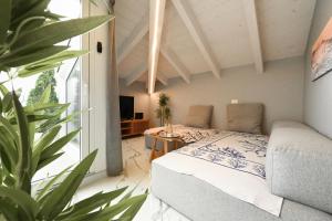 a bedroom with a bed and a potted plant at Camere Amely in Sanremo