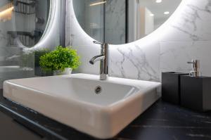 a white sink in a bathroom with a mirror at Smart Space in La Mata +34 photos