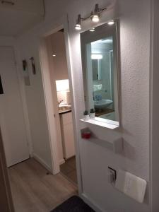 a bathroom with a sink and a mirror at Ferienwohnung mit Ostseeblick & Strandlage in Sierksdorf +37 photos