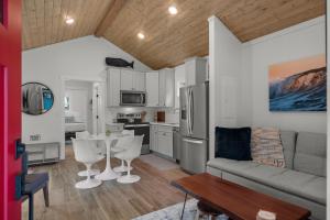 a kitchen and living room with a couch and a table at Sara Sea by Seabrook Hospitality in Pacific Beach