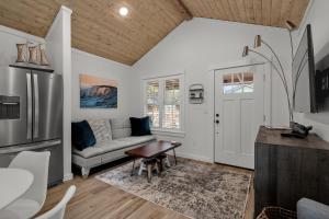 a living room with a couch and a table at Sara Sea by Seabrook Hospitality in Pacific Beach
