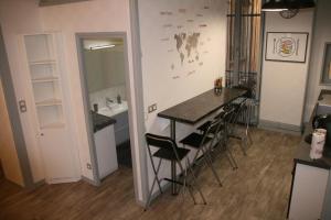 a kitchen with a table and chairs in a room at Chez Mo in Lyon