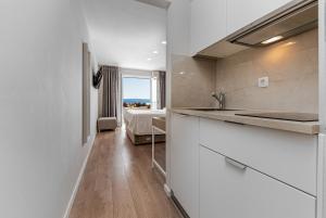 a bathroom with a sink and a bedroom with a bed at Apartments Kartulina in Brela +45 photos