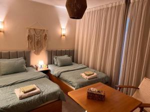 a room with two twin beds and a table at Romantic Cozy Studio Bali Gouna in Hurghada