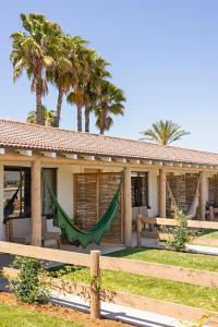 a house with a hammock in front of it at River Lodge Paso in Paso Robles