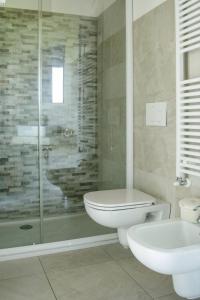 a bathroom with a toilet and a sink and a shower at Rama Relais in Caprino Veronese +63 photos