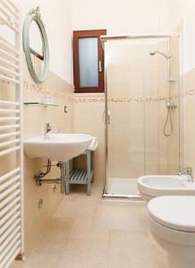 a bathroom with a shower and a sink and a toilet at Tenuta TerraLuna in Collepasso