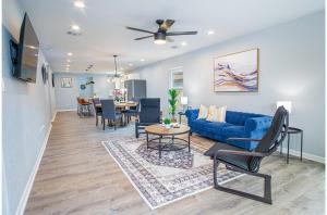 a living room with a blue couch and a table at Spacious Delightful 4 BR 3 BA Close to Downtown in San Antonio
