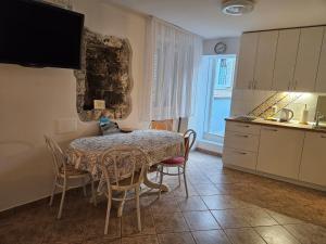 a kitchen with a table and chairs in a kitchen at Don Dolfino Guesthouse - Hiša Dolfinova vrata in Piran +42 photos